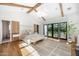 Spacious main bedroom with hardwood floors, beamed ceilings, and French doors leading to the backyard at 6235 E Montecito Ave, Scottsdale, AZ 85251