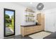 Mud room featuring built-in storage, black countertops, and stylish accents at 6235 E Montecito Ave, Scottsdale, AZ 85251