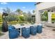 Inviting outdoor dining area with a large table, seating for ten, heat lamps and lush greenery, perfect for entertaining at 6235 E Montecito Ave, Scottsdale, AZ 85251