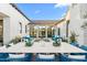 Elegant outdoor dining area with seating, tranquil water feature, and blue decor at 6235 E Montecito Ave, Scottsdale, AZ 85251