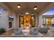 Inviting outdoor patio with fireplace, comfortable seating and lighting for nighttime enjoyment at 6235 E Montecito Ave, Scottsdale, AZ 85251
