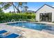 Luxury pool area showcasing water fountains, comfortable lounge chairs, and a well-manicured garden with flowering bushes at 6235 E Montecito Ave, Scottsdale, AZ 85251