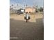 Backyard with gravel, fire pit, and neighboring homes visible at 625 W Mckellips Rd # 115, Mesa, AZ 85201