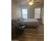 Bright bedroom with double bed, chair, and window coverings at 625 W Mckellips Rd # 115, Mesa, AZ 85201