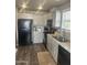 Modern kitchen features gray cabinets, granite countertops, black appliances, and wood-look floors at 625 W Mckellips Rd # 115, Mesa, AZ 85201