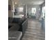 Spacious living room with L-shaped sectional sofa, wood-look floors, and kitchen island at 625 W Mckellips Rd # 115, Mesa, AZ 85201