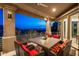 Covered patio with seating area offering stunning sunset and city views at 7060 N Hillside Dr, Paradise Valley, AZ 85253