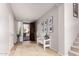 Bright entryway with tile flooring, bench, and coat closet at 739 E Lovebird Ln, Gilbert, AZ 85297