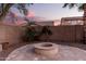 Stone fire pit in a landscaped backyard at dusk at 739 E Lovebird Ln, Gilbert, AZ 85297