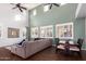 Spacious living room with high ceilings, hardwood floors, and large windows at 739 E Lovebird Ln, Gilbert, AZ 85297