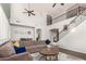 Two-story living room with sectional sofa, high ceilings, and hardwood floors at 739 E Lovebird Ln, Gilbert, AZ 85297