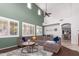 Open living room with sectional sofa, high ceilings, and hardwood floors at 739 E Lovebird Ln, Gilbert, AZ 85297