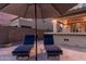 Patio with lounge chairs and umbrella, near outdoor kitchen at 739 E Lovebird Ln, Gilbert, AZ 85297