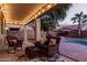 Relaxing covered patio with wicker furniture and string lights at 739 E Lovebird Ln, Gilbert, AZ 85297