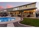 Spacious covered patio with seating area, outdoor kitchen, and pool view at 739 E Lovebird Ln, Gilbert, AZ 85297