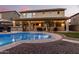 Large covered patio with outdoor kitchen and pool access at 739 E Lovebird Ln, Gilbert, AZ 85297