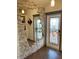Inviting entryway with stone wall accent and stained-glass door at 7750 E Broadway Rd # 125, Mesa, AZ 85208
