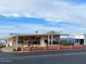 Single-wide manufactured home with covered porch and desert landscaping at 7750 E Broadway Rd # 125, Mesa, AZ 85208