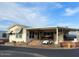 Single-wide manufactured home with covered patio and carport at 7750 E Broadway Rd # 125, Mesa, AZ 85208