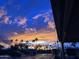 Beautiful sunset over a mobile home community featuring palm trees against a blue sky at 7750 E Broadway Rd # 125, Mesa, AZ 85208
