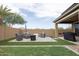 Spacious backyard patio with seating area, fire pit, and grill at 809 W Palo Verde Dr, Casa Grande, AZ 85122