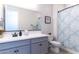 Clean bathroom with gray vanity, white toilet, and shower at 809 W Palo Verde Dr, Casa Grande, AZ 85122