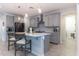 Modern kitchen with gray cabinets, quartz countertops, and stainless steel appliances at 809 W Palo Verde Dr, Casa Grande, AZ 85122