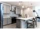 Modern kitchen features gray cabinets, quartz countertops, and island with seating at 809 W Palo Verde Dr, Casa Grande, AZ 85122