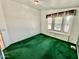 Bright bedroom featuring green carpet and a bay window at 8500 E Southern Ave # 405, Mesa, AZ 85209