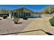 Light yellow single story home with attached garage and desert landscaping at 8500 E Southern Ave # 405, Mesa, AZ 85209