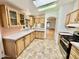 Efficient kitchen with wood cabinets and a tile floor at 8500 E Southern Ave # 405, Mesa, AZ 85209