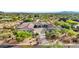 Luxury home with circular driveway, desert landscape, and mountain views at 9045 E Chino Dr, Scottsdale, AZ 85255