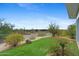 Landscaped backyard with artificial turf and desert landscaping at 9045 E Chino Dr, Scottsdale, AZ 85255
