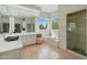 Elegant bathroom with stone flooring, soaking tub, and walk-in shower at 9045 E Chino Dr, Scottsdale, AZ 85255
