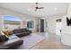 Open living room features stone floors, modern furniture, and ample natural light from large windows at 9045 E Chino Dr, Scottsdale, AZ 85255