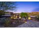 Luxury home's exterior at night; desert landscaping with stone accents at 9127 N Fireridge Trl, Fountain Hills, AZ 85268