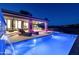 Night view of the pool and patio with water feature and lounge chairs at 9127 N Fireridge Trl, Fountain Hills, AZ 85268