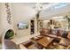 Spacious living room featuring a leather sectional sofa, fireplace, and high ceilings at 9463 N 105Th N Pl, Scottsdale, AZ 85258