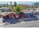 Aerial view of two houses with surrounding neighborhood and city skyline in background at 1021 E Roosevelt St, Phoenix, AZ 85006