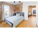 Cozy bedroom with exposed brick wall, and hardwood floors at 1021 E Roosevelt St, Phoenix, AZ 85006