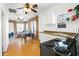 Open kitchen with exposed brick, white cabinets, and a stove at 1021 E Roosevelt St, Phoenix, AZ 85006