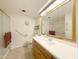 Well-lit bathroom features wood vanity, tile floors, and shower with sliding glass doors at 10330 W Thunderbird Blvd # A125, Sun City, AZ 85351