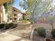 Exterior view showcasing the lush courtyard area with desert landscaping and multi-story buildings at 10330 W Thunderbird Blvd # A125, Sun City, AZ 85351