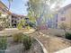 Beautiful courtyard featuring mature landscaping, gravel pathways, and cozy gazebo at 10330 W Thunderbird Blvd # A125, Sun City, AZ 85351