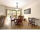 Dining area with wood floors and sliding glass door access to courtyard at 10330 W Thunderbird Blvd # A125, Sun City, AZ 85351