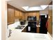 Well-equipped kitchen featuring wood cabinets and black appliances at 10330 W Thunderbird Blvd # A125, Sun City, AZ 85351
