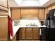 Functional kitchen with wood cabinets and modern appliances at 10330 W Thunderbird Blvd # A125, Sun City, AZ 85351