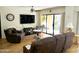 Bright living room with hardwood floors, comfortable seating, and access to a patio at 10330 W Thunderbird Blvd # A125, Sun City, AZ 85351