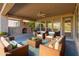 Relaxing covered patio featuring a fireplace and seating area at 12750 W Jasmine Trl, Peoria, AZ 85383
