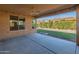 Covered patio overlooking the backyard with a fireplace at 12750 W Jasmine Trl, Peoria, AZ 85383